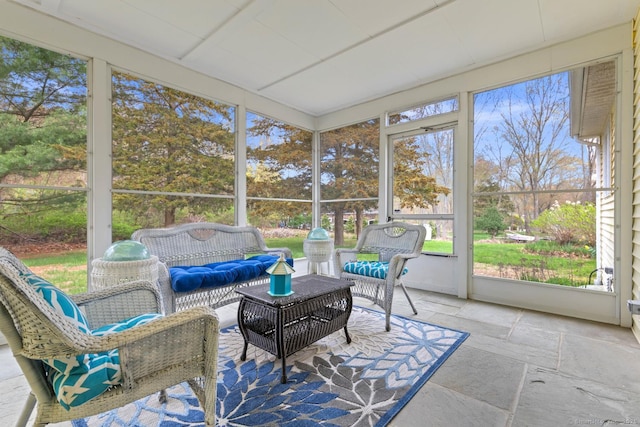 sunroom / solarium featuring an outdoor living space and a wealth of natural light