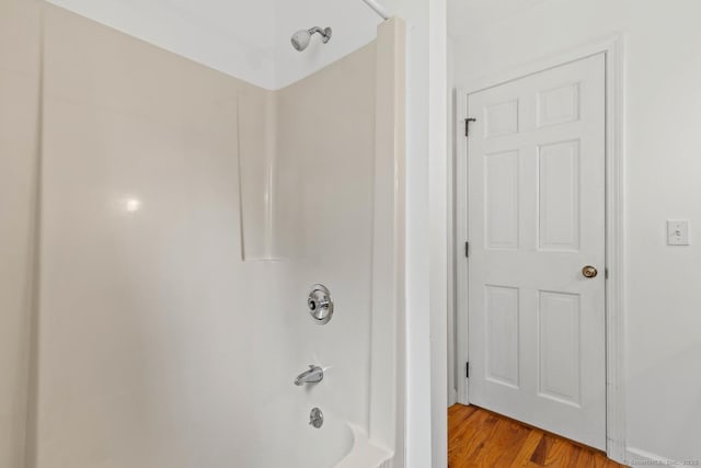 bathroom featuring shower / tub combination and wood finished floors