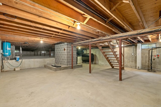 unfinished basement with stairway and heating fuel