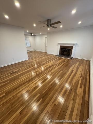 71 Schiller Rd, Fairfield, CT 06825 - unfurnished living room with a ceiling fan, wood finished floors, recessed lighting, and a fireplace with raised hearth