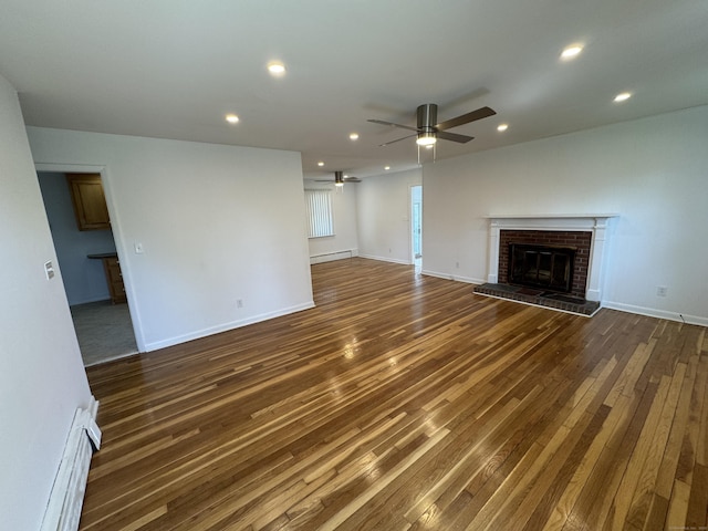 71 Schiller Rd, Fairfield, CT 06825 - unfurnished living room featuring a baseboard radiator, a ceiling fan, a fireplace, dark wood-style floors, and recessed lighting