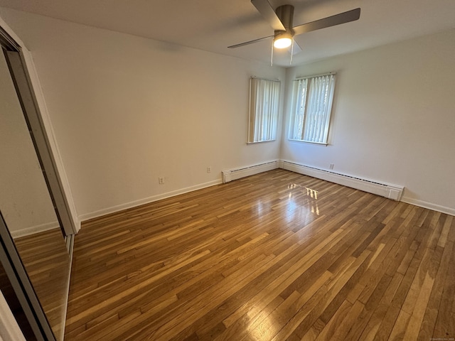 71 Schiller Rd, Fairfield, CT 06825 - unfurnished bedroom with a baseboard heating unit, hardwood / wood-style flooring, baseboards, and a ceiling fan