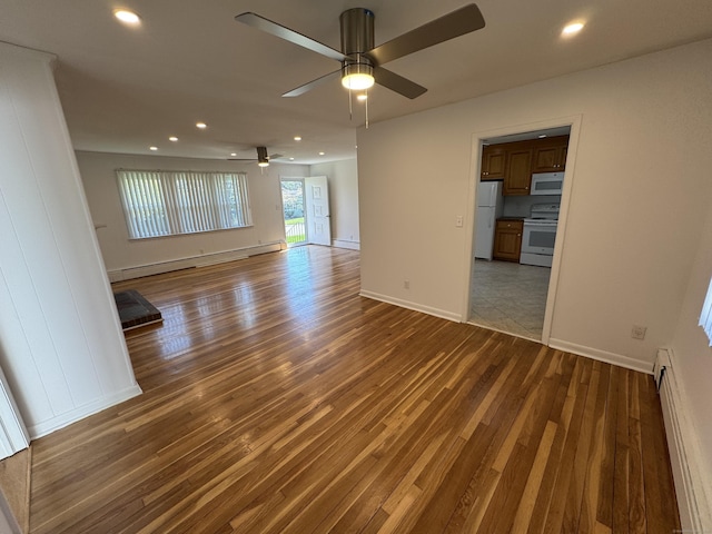 71 Schiller Rd, Fairfield, CT 06825 - empty room with baseboard heating, wood finished floors, recessed lighting, and ceiling fan