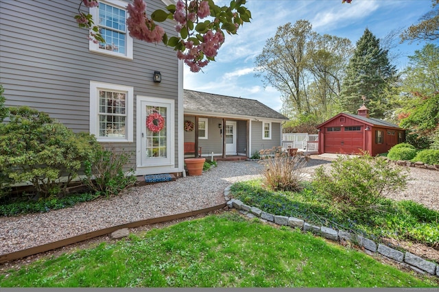 exterior space with a garage, an outbuilding, and driveway