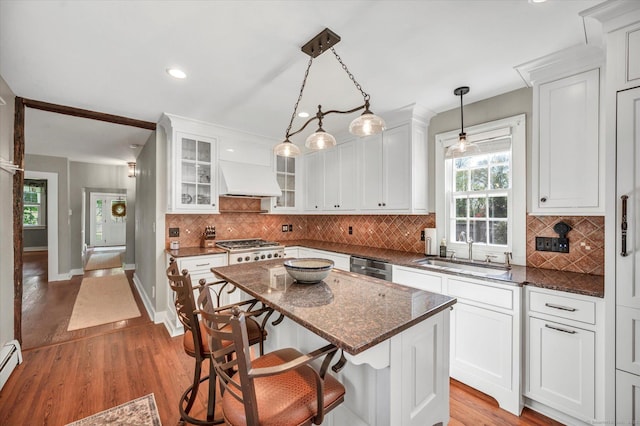 kitchen with white cabinetry, a sink, and light wood-type flooring