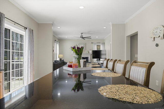 dining room with a fireplace, a ceiling fan, ornamental molding, and recessed lighting