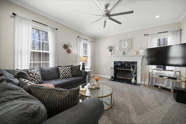 carpeted living room featuring crown molding, a ceiling fan, and a wealth of natural light