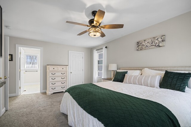 carpeted bedroom featuring baseboards and a ceiling fan