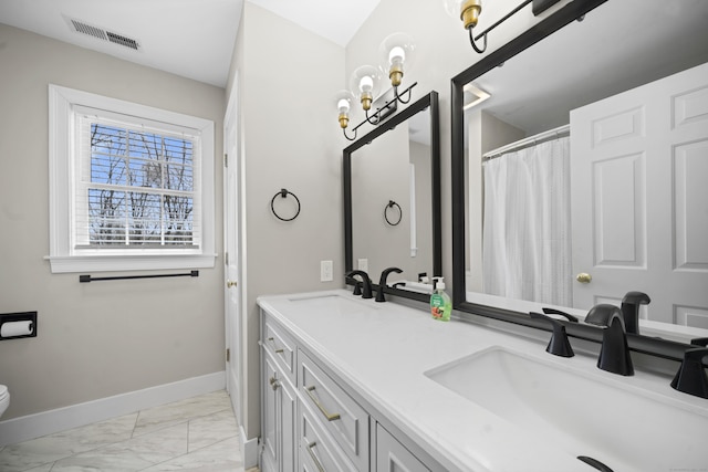 bathroom with a sink, visible vents, baseboards, toilet, and marble finish floor