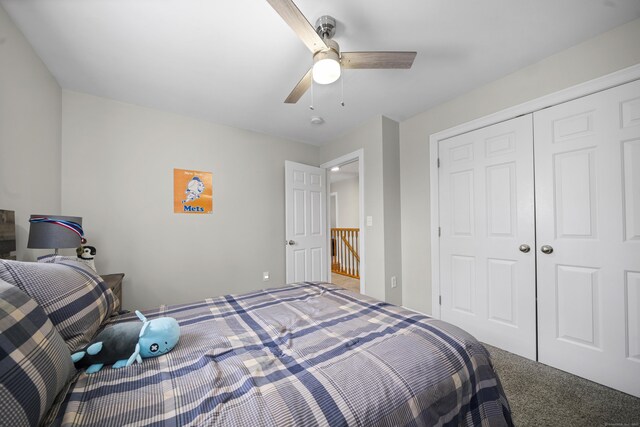 carpeted bedroom featuring a ceiling fan and a closet
