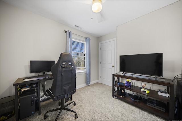 home office with carpet flooring, visible vents, ceiling fan, and baseboards