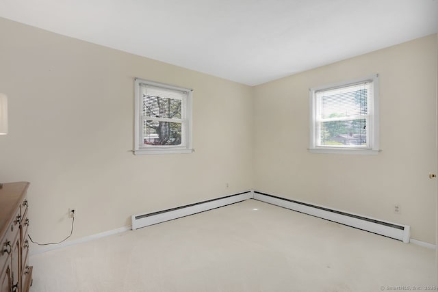 unfurnished room with baseboards, light colored carpet, and a wealth of natural light