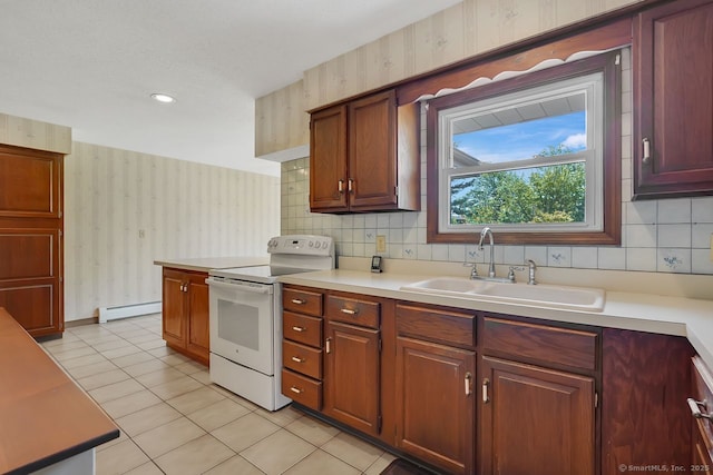 kitchen with wallpapered walls, a baseboard heating unit, white range with electric stovetop, a sink, and light tile patterned floors