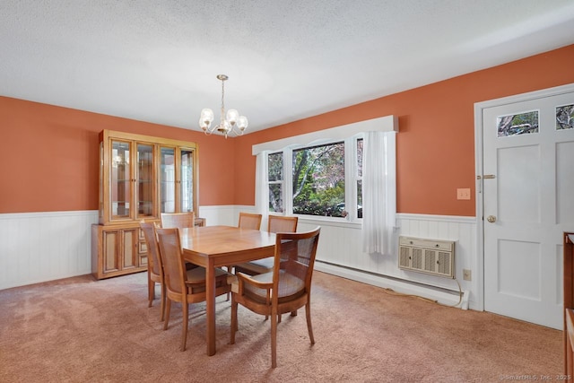 dining area with a notable chandelier, wainscoting, and light colored carpet