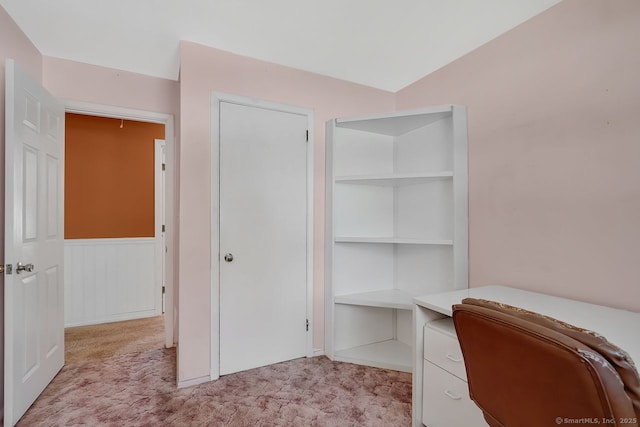 unfurnished office featuring wainscoting and light colored carpet