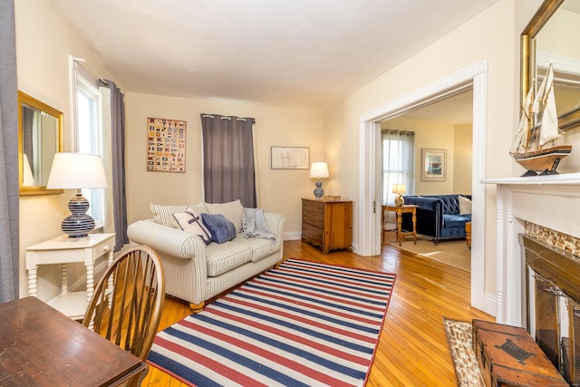 16 Pearl St, Groton, CT 06355 - living area with baseboards, plenty of natural light, a fireplace, and light wood-style flooring