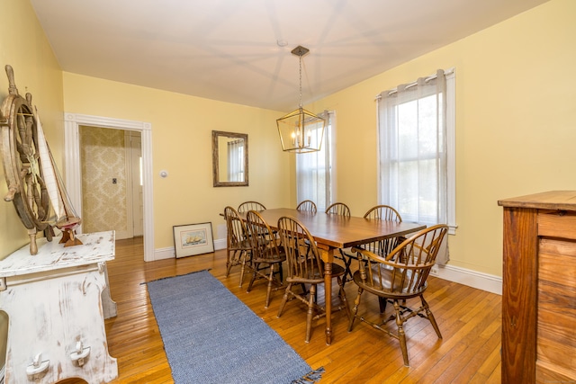 16 Pearl St, Groton, CT 06355 - dining room with baseboards, light wood finished floors, and a chandelier