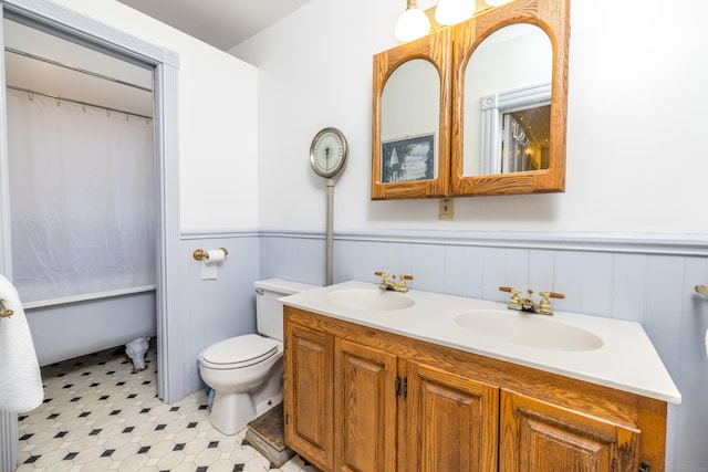 16 Pearl St, Groton, CT 06355 - full bath with double vanity, a sink, wainscoting, and toilet
