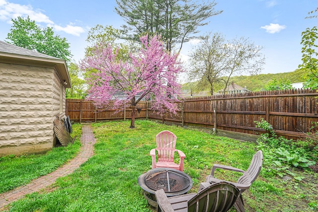 view of yard with an outdoor fire pit