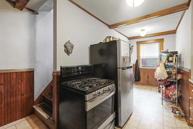 kitchen with gas stove, a wainscoted wall, tile patterned floors, wooden walls, and beam ceiling