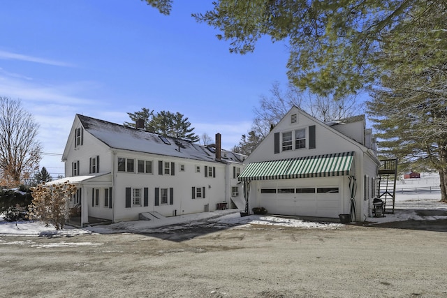 802 State Rd, Richmond, MA 01254 - view of front of home with dirt driveway, an attached garage, and a chimney