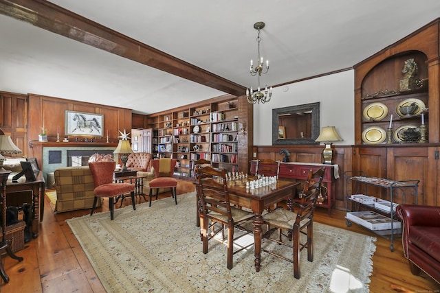802 State Rd, Richmond, MA 01254 - dining room featuring hardwood / wood-style floors, wood walls, built in features, and a notable chandelier
