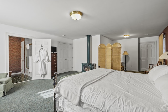 802 State Rd, Richmond, MA 01254 - carpeted bedroom with ensuite bathroom, baseboards, and a wood stove