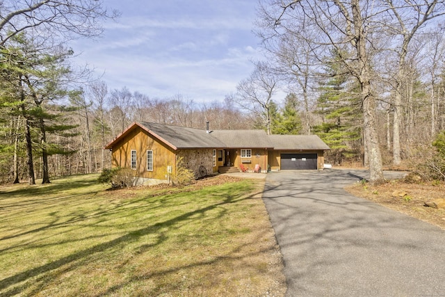 view of front of house with a front lawn, a garage, and aphalt driveway