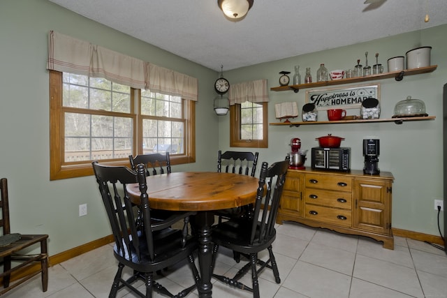 dining room with baseboards and light tile patterned flooring