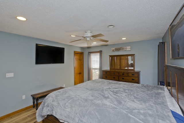 bedroom featuring recessed lighting, a textured ceiling, and wood finished floors