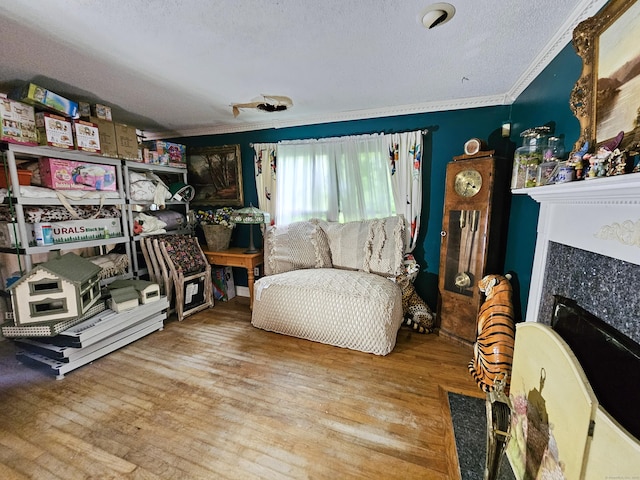 935 Gaylord Mountain Rd, Hamden, CT 06518 - sitting room featuring ornamental molding, a textured ceiling, wood finished floors, and a fireplace