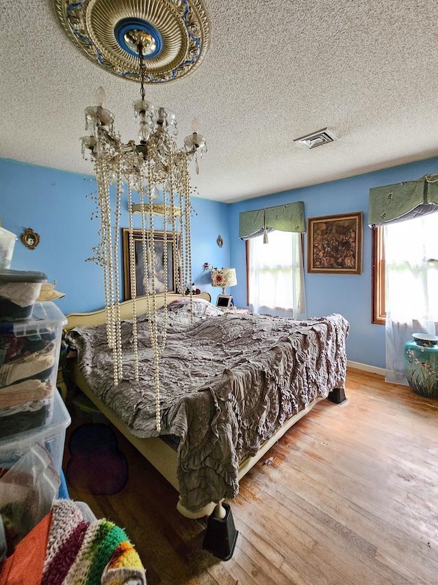 935 Gaylord Mountain Rd, Hamden, CT 06518 - bedroom with multiple windows, wood finished floors, a textured ceiling, and baseboards