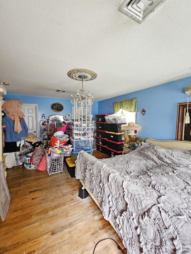 935 Gaylord Mountain Rd, Hamden, CT 06518 - bedroom with wood finished floors, a textured ceiling, and a chandelier