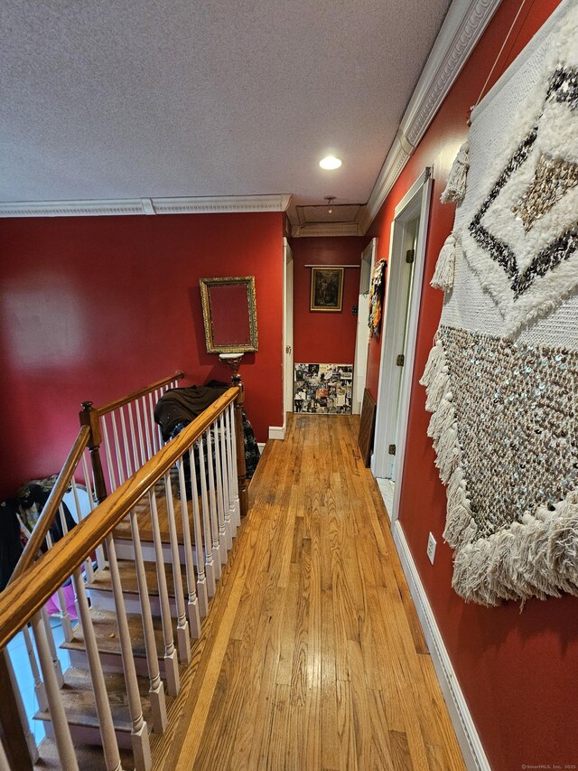 935 Gaylord Mountain Rd, Hamden, CT 06518 - corridor with a textured ceiling, crown molding, wood finished floors, baseboards, and an upstairs landing