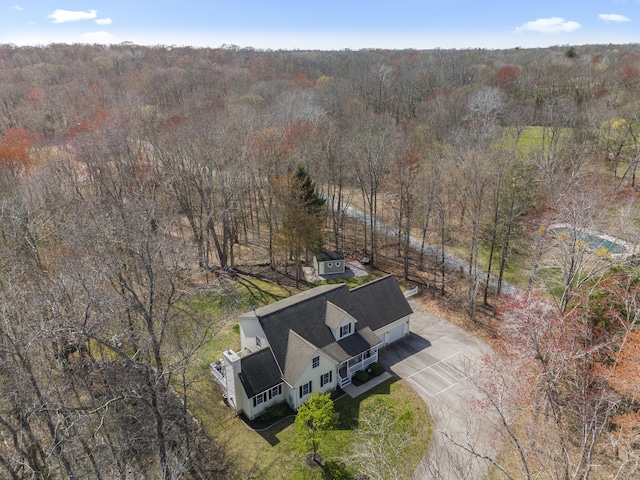 drone / aerial view with a wooded view