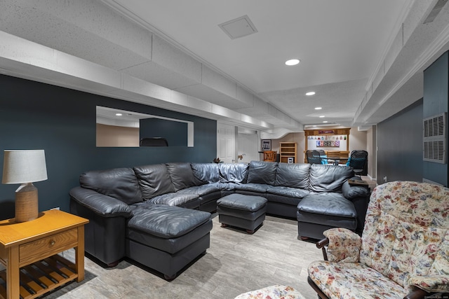 living area featuring recessed lighting, ornamental molding, light wood-type flooring, and indoor bar