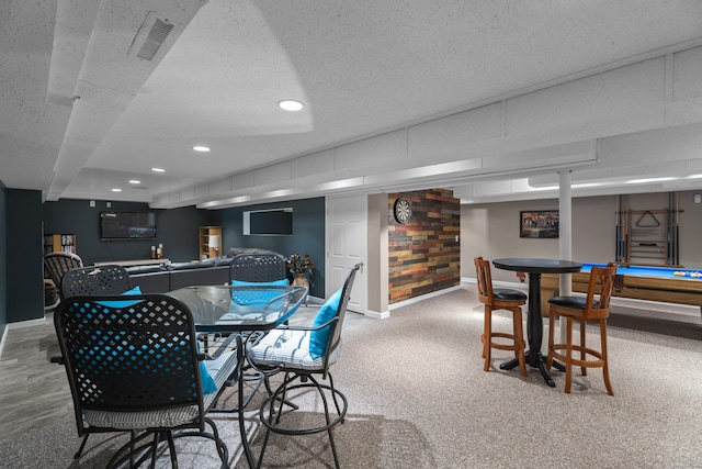 interior space featuring recessed lighting, carpet flooring, baseboards, visible vents, and a textured ceiling