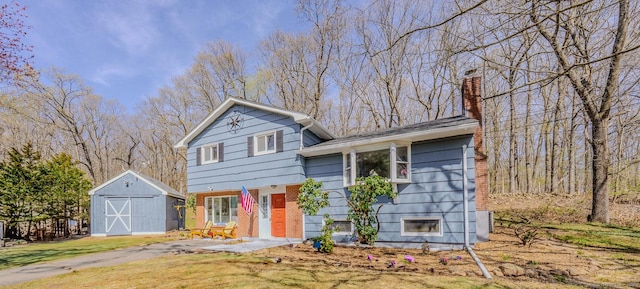 106 Lorraine Ter, Middletown, CT 06457 - split level home with a front lawn, an outbuilding, a chimney, a shed, and brick siding