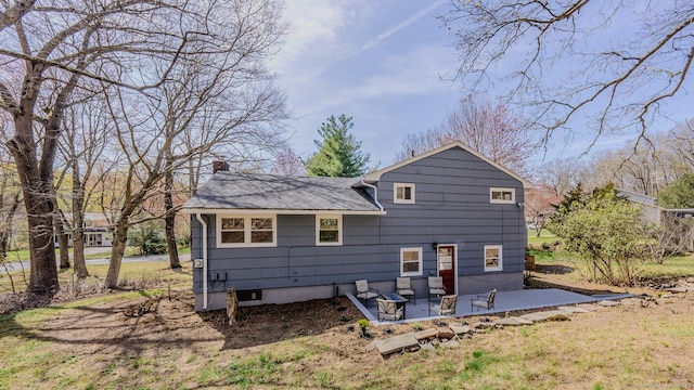 106 Lorraine Ter, Middletown, CT 06457 - rear view of house featuring roof with shingles, a chimney, and a patio area
