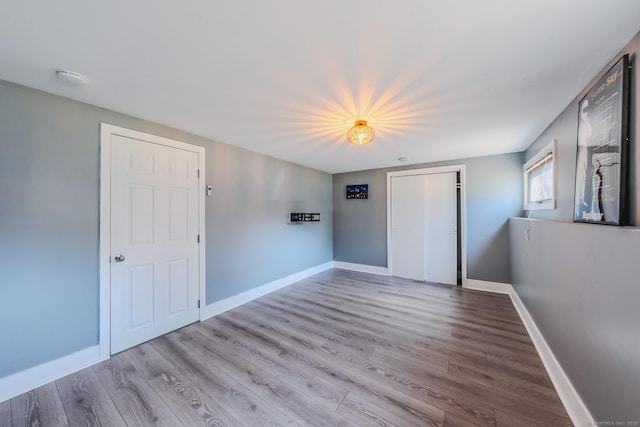 106 Lorraine Ter, Middletown, CT 06457 - unfurnished bedroom featuring a closet, wood finished floors, and baseboards