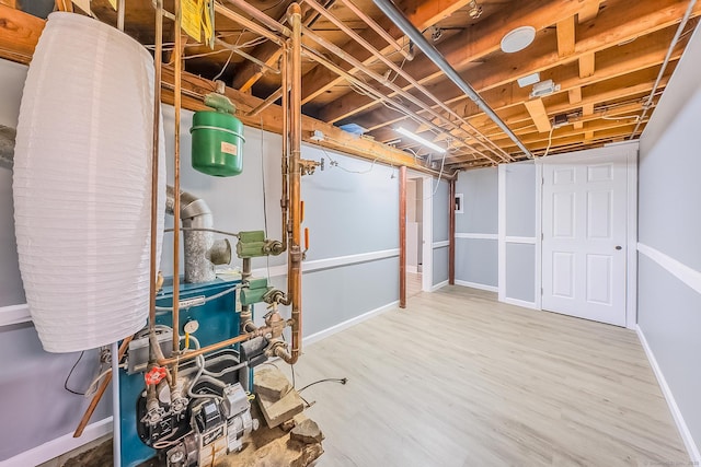 106 Lorraine Ter, Middletown, CT 06457 - unfinished basement with baseboards, wood finished floors, and a heating unit