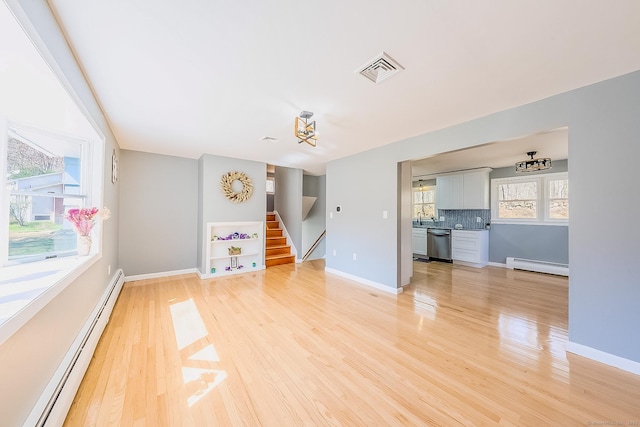 106 Lorraine Ter, Middletown, CT 06457 - unfurnished living room featuring visible vents, light wood-style flooring, and baseboard heating