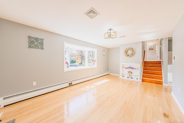 106 Lorraine Ter, Middletown, CT 06457 - empty room with baseboard heating, visible vents, wood finished floors, and stairway