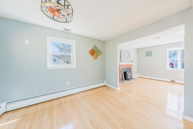 106 Lorraine Ter, Middletown, CT 06457 - unfurnished living room featuring visible vents, baseboard heating, and a healthy amount of sunlight