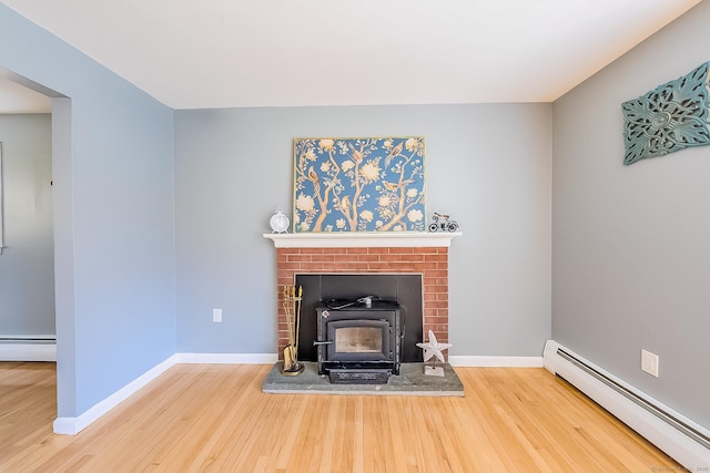 106 Lorraine Ter, Middletown, CT 06457 - details with a wood stove, wood finished floors, and a baseboard radiator