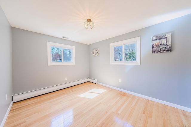 106 Lorraine Ter, Middletown, CT 06457 - spare room with wood finished floors, visible vents, a baseboard heating unit, and baseboards