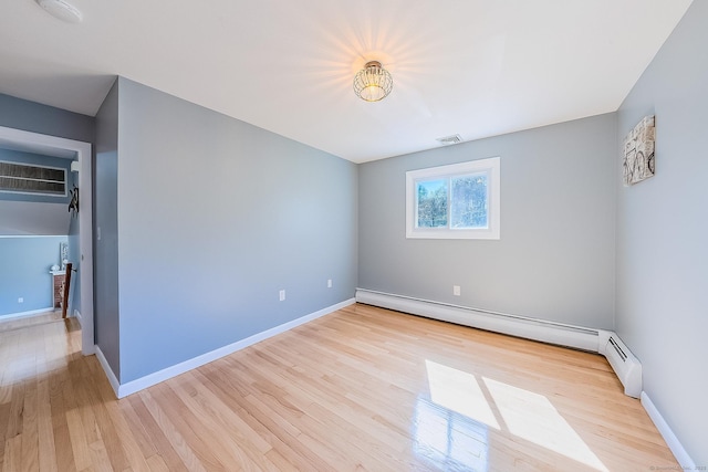 106 Lorraine Ter, Middletown, CT 06457 - spare room featuring visible vents, baseboard heating, wood finished floors, and baseboards