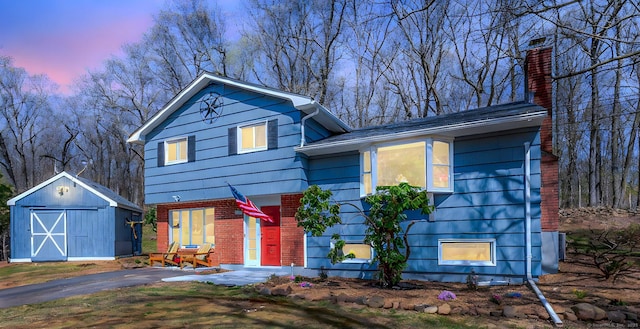 106 Lorraine Ter, Middletown, CT 06457 - tri-level home with an outdoor structure, a chimney, a shed, and brick siding