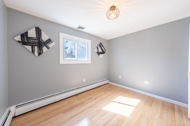106 Lorraine Ter, Middletown, CT 06457 - unfurnished room with wood finished floors, visible vents, a baseboard heating unit, and baseboards