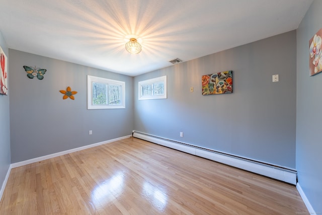 106 Lorraine Ter, Middletown, CT 06457 - empty room with wood finished floors, visible vents, baseboard heating, and baseboards